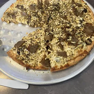 Gluten free crust pizza with gyro meat onion black olives feta and taziki sauce. Mother loved it.