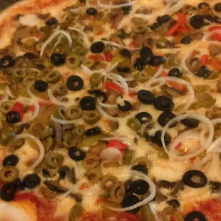 a pizza with olives and onions