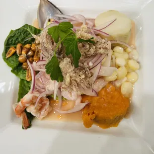 Ceviche Mixto (seafood mixed, Red snapper, prawns, mussel and calamari. Served lime juice, sweet potato, corn and Fresh onion on top)