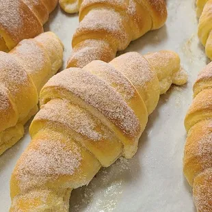 freshly baked croissants on a baking sheet