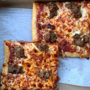 two slices of pizza in a box