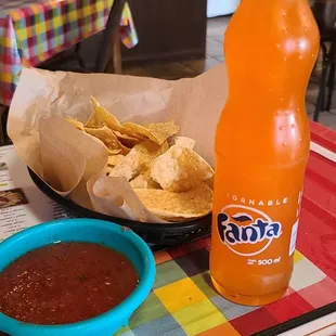 a bottle of soda and chips