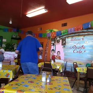 a man walking through the dining room