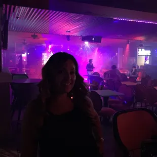 a woman standing in front of a bar