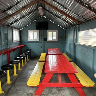 a red table and yellow benches