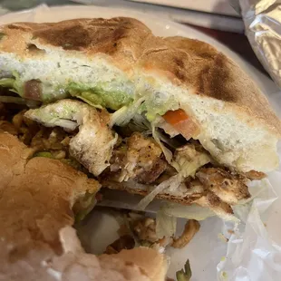 Chicken torta - comes with beans, avocado, lettuce, onion and tomato and a side of Chile toreado