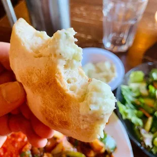 a hand holding a piece of bread