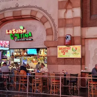people sitting at tables in a restaurant