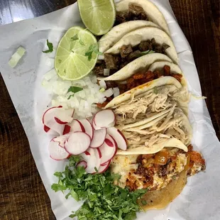 a plate of tacos and radishes