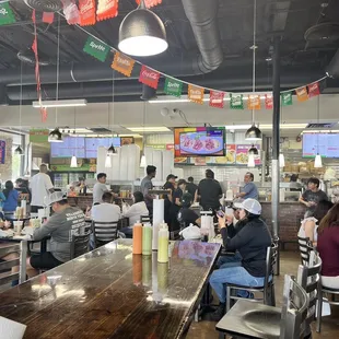 people sitting at tables in a restaurant