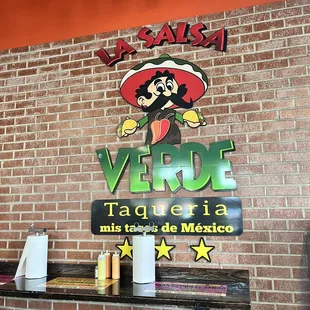 a sign on a brick wall