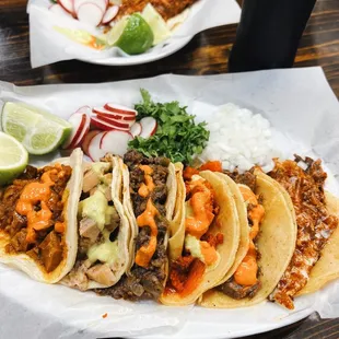 a plate of tacos and a drink