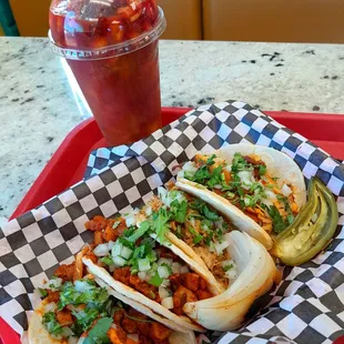 Street tacos: pastor, carnitas, pollo. And a spicy mangoneada.