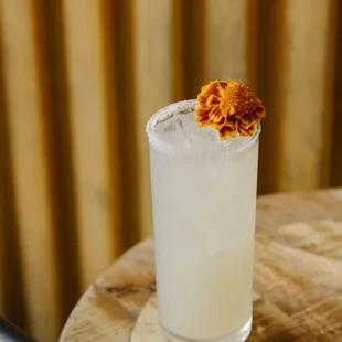 a margarita with a flower on the rim