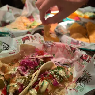 a plate of tacos and chips