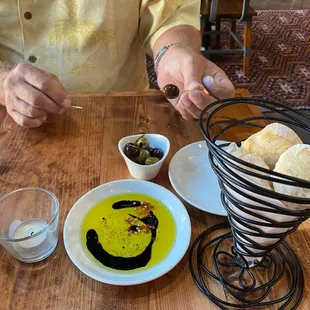Complimentary bread bites, balsamic and olive oil dipping and marinated olives.