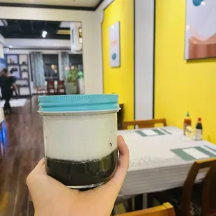 a person holding a cup of coffee