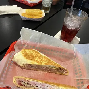 Pictured: Cuban wrap, Yuca Fries, red sangria, rum and Coke.