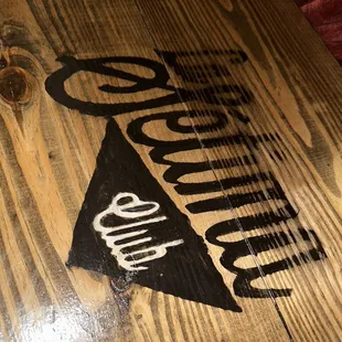 a wooden table with a sign on it