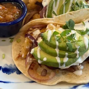 a plate of tacos and a bowl of salsa