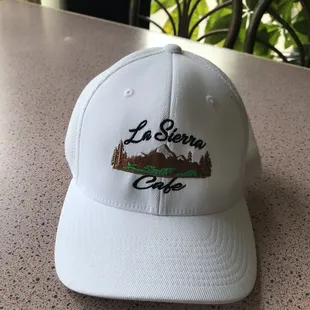 a white hat with the la sierra cafe embroidered on it