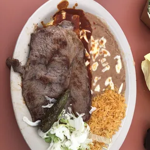 Carne asada with an enchilada, it&apos;s underneath, you can&apos;t really see it, but it&apos;s yummy.