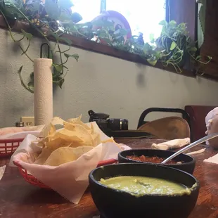 a bowl of guacamole and a bowl of chips
