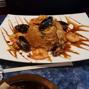 First time here...we were impressed. The food was fresh and this lovely Peruvian seafood dish was $14 and enough food for 2 people!