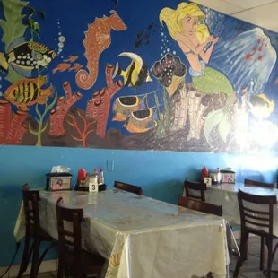 a mural of a mermaid and fish