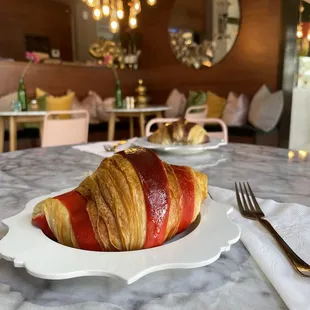 a croissant on a white plate