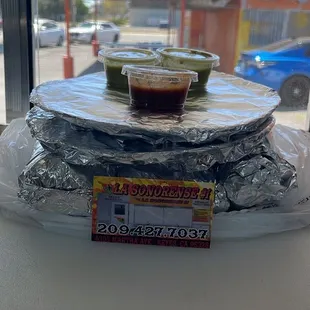 a stack of foil wrapped tortillas