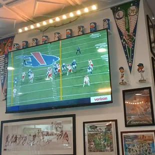 Game on the TV with Dodgers and Lakers memorabilia