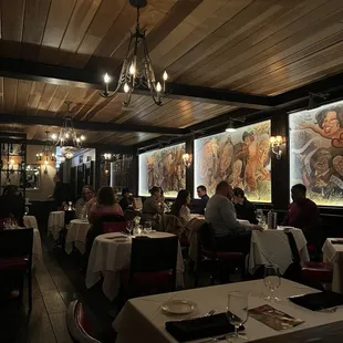 people sitting at tables in a restaurant