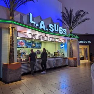 two people standing at the counter