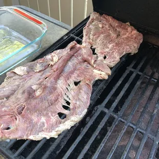 he meat being cooked on the grill