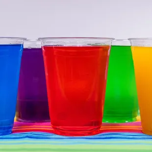 a row of different colored drinks