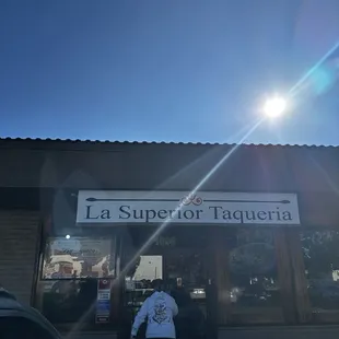 a person standing in front of a restaurant