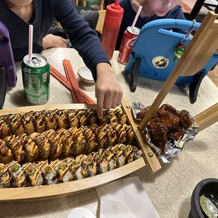 Sushi boat with Two fried rolls and mango habanero wings