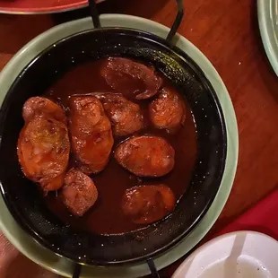 a bowl of stew with sausages