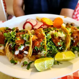 Taco plate with spicy red sauce (chorizo, al pastor, asada)
