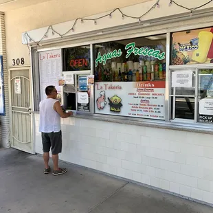a man standing in front of a store