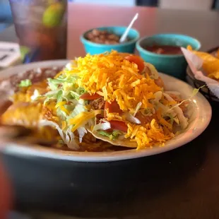 Wonderful Tex-Mex plate with chalupa, enchilada, taco, rice and beans. It's a lot of food and enough for two meals!