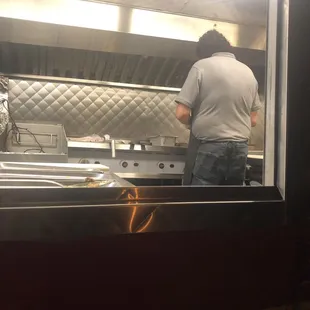 The owner fixing up delicious hot fresh food