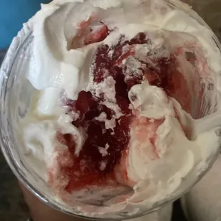 a cup of ice cream and strawberries
