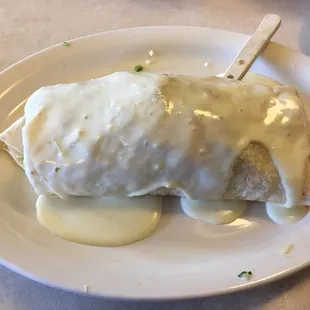 Giant Burrito topped with cheese sauce