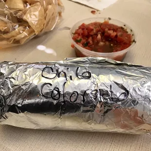 a burrito wrapped in aluminum foil