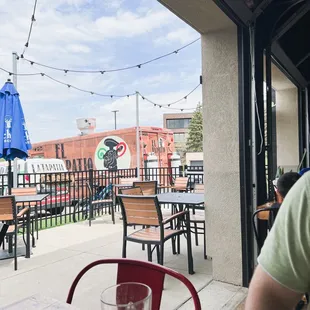 Three garage doors open to the patio