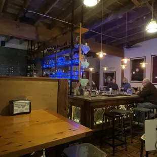 people sitting at tables in a restaurant