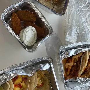 a variety of tacos in tinfoils