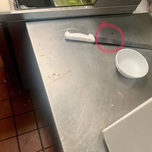 a knife and a bowl on a counter
